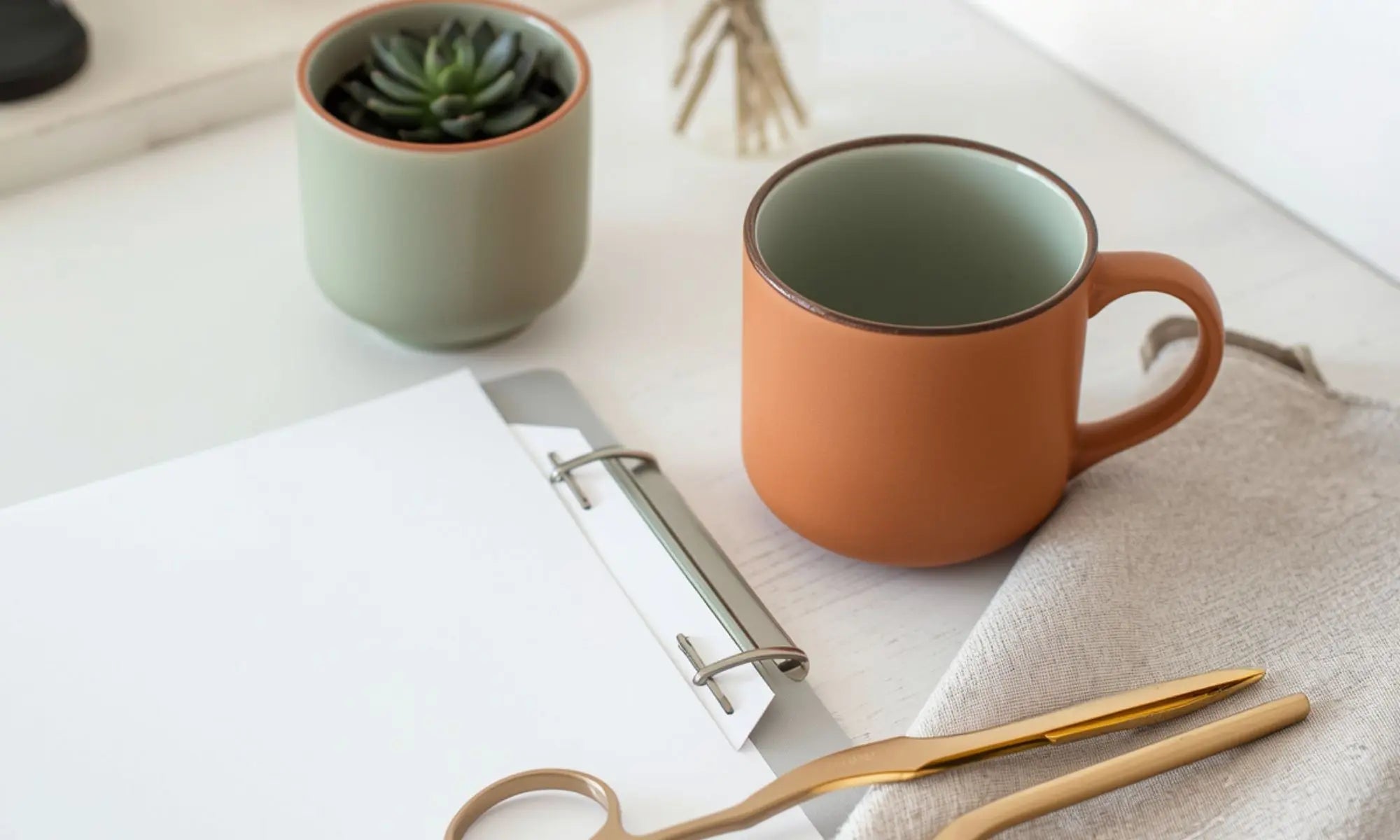 image of a teacher's desk with a laptop and inspirational artwork