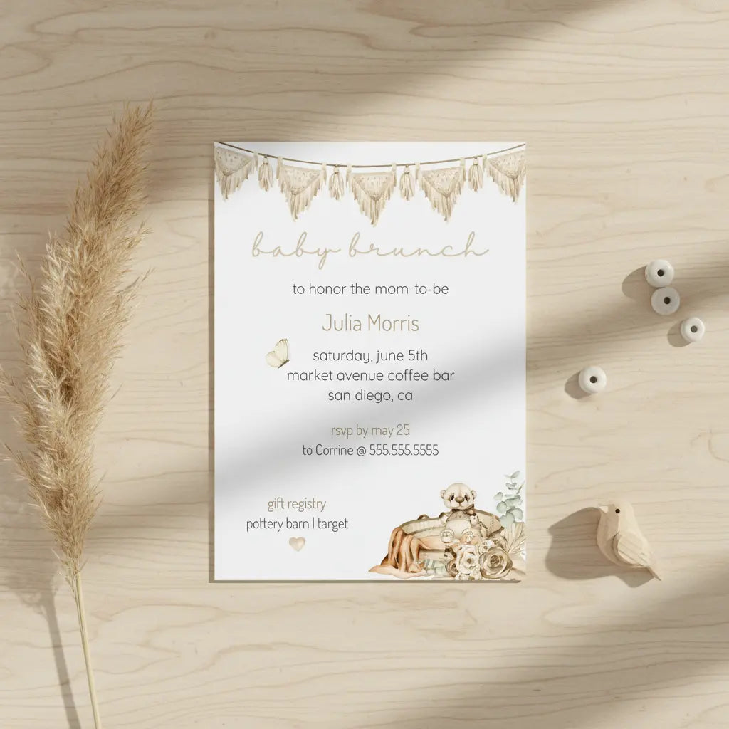 Personalized bohemian baby shower invitation card on a wooden surface with decorative elements