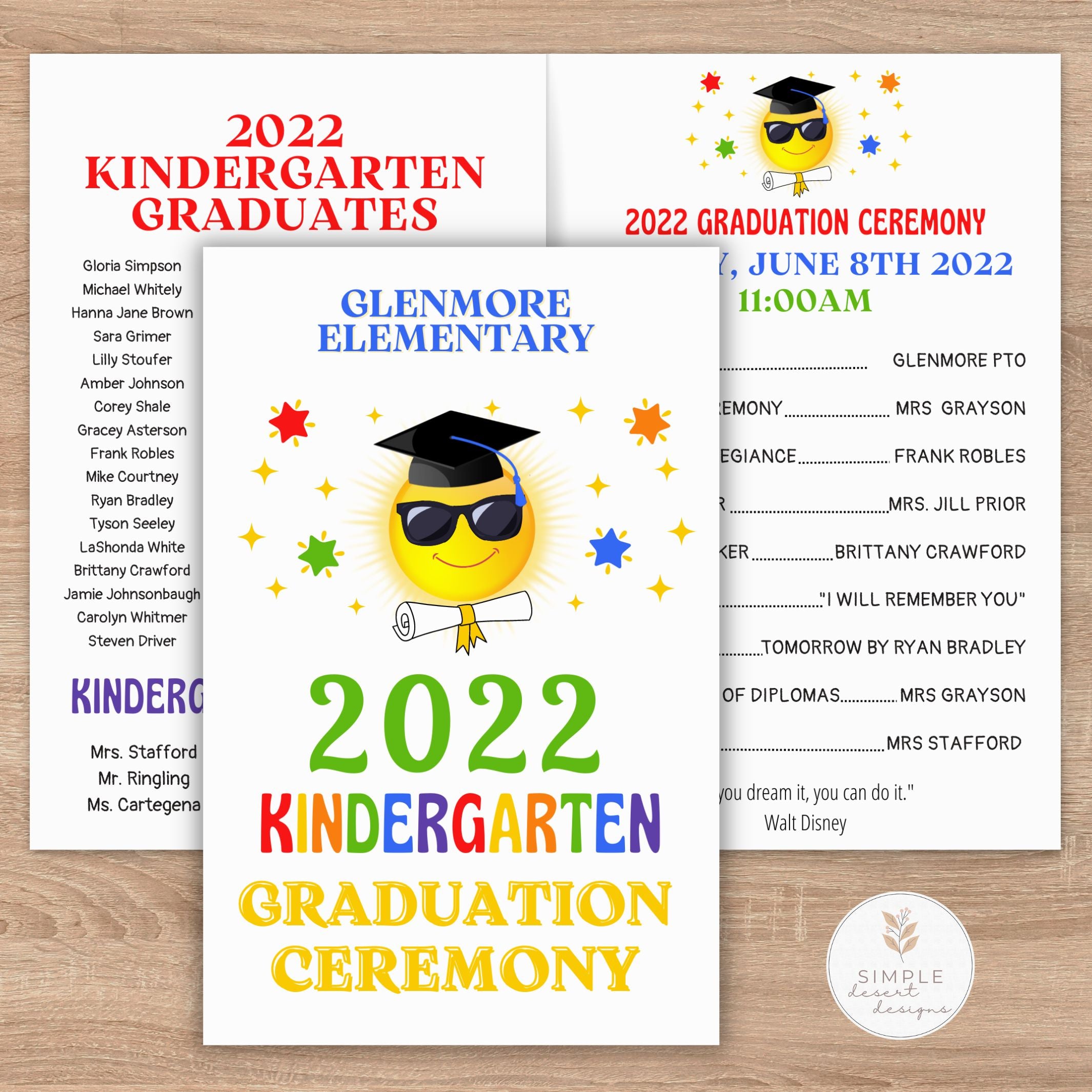 Kindergarten graduation ceremony invitations with a smiling emoji wearing a cap and diploma on a wooden surface.
