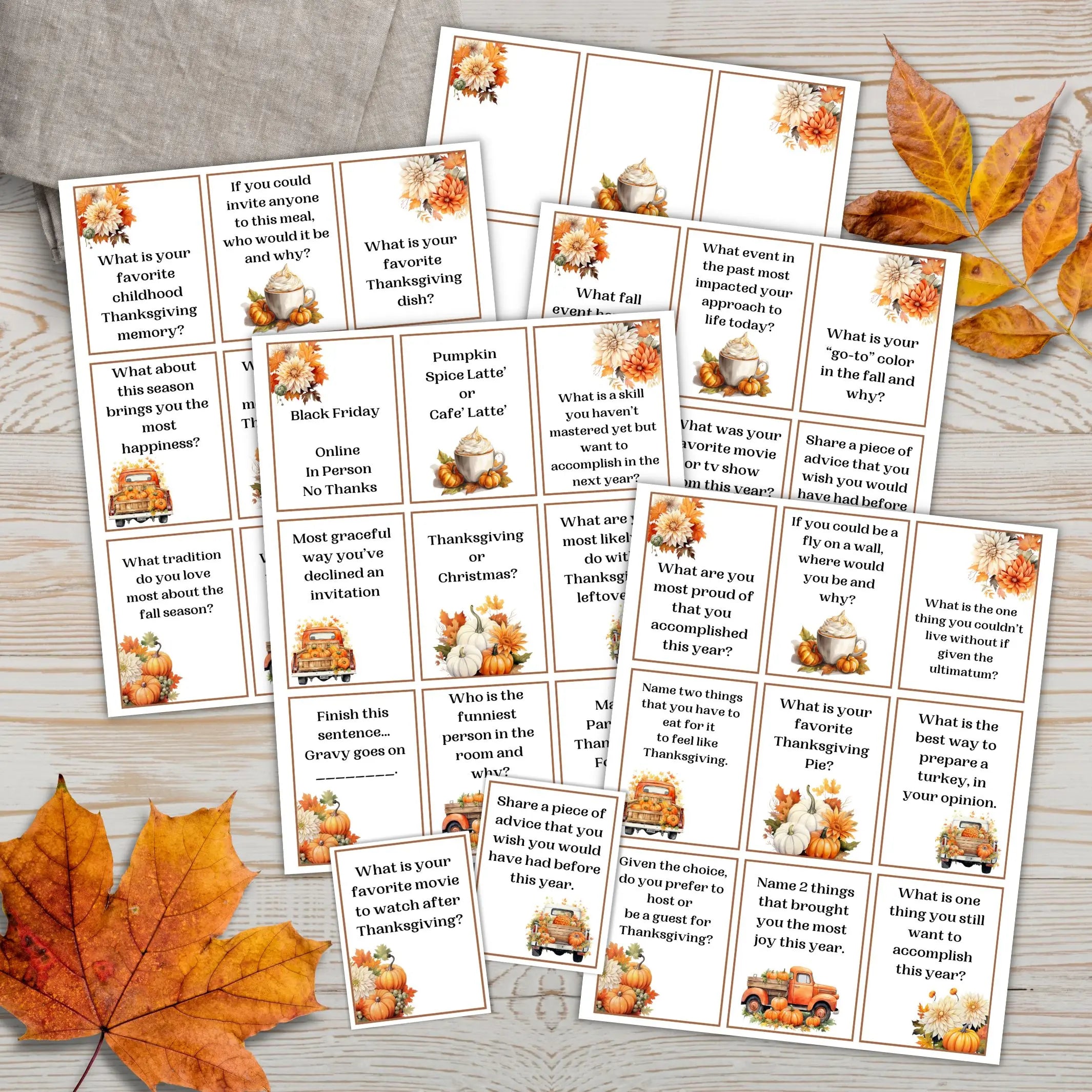 Set of Thanksgiving-themed ice breaker question cards on a wooden surface with autumn leaves.