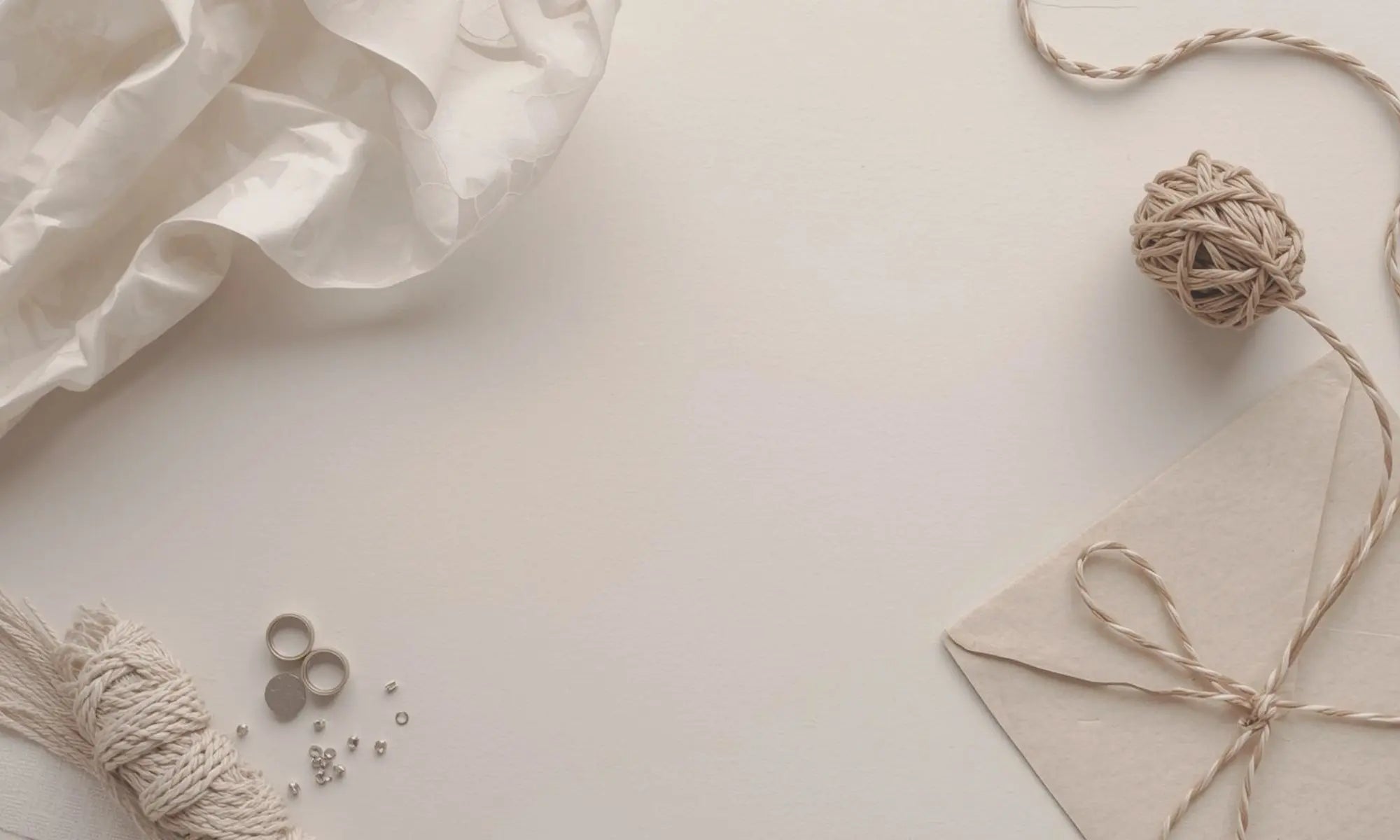 neutral surface with twine and envelopes and other neutral desk accessories