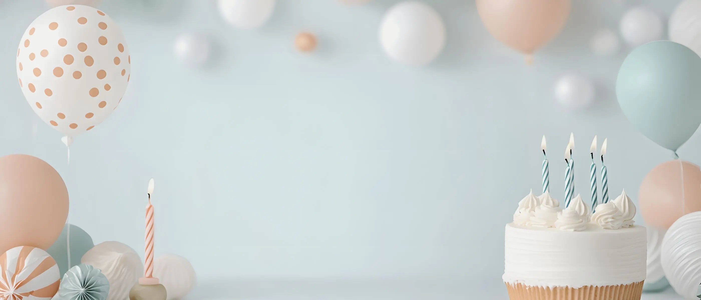 celebration setting with balloons cupcakes and candles in soft neutral colors