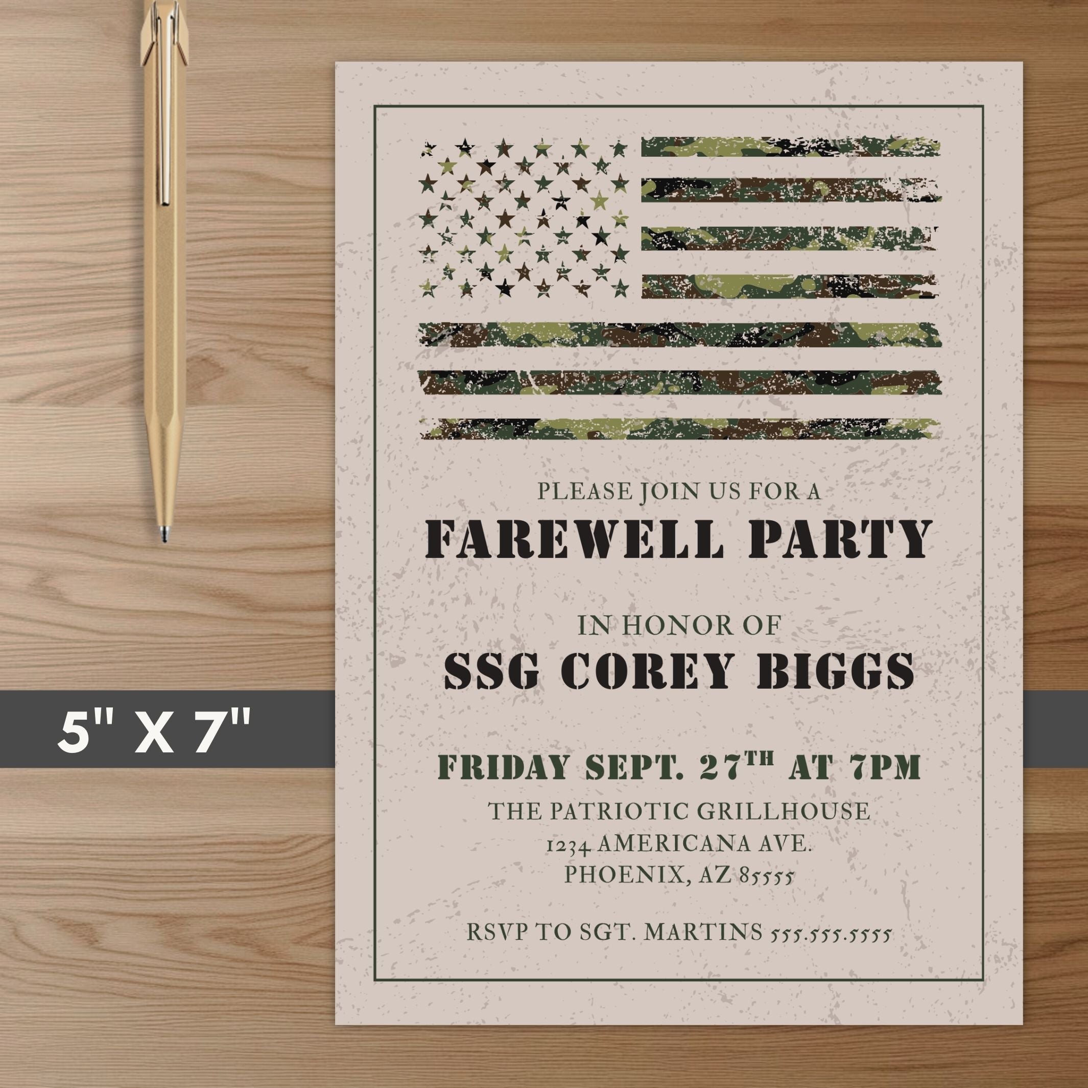 Farewell party invitation with camouflage American flag design on a wooden surface with a pen.