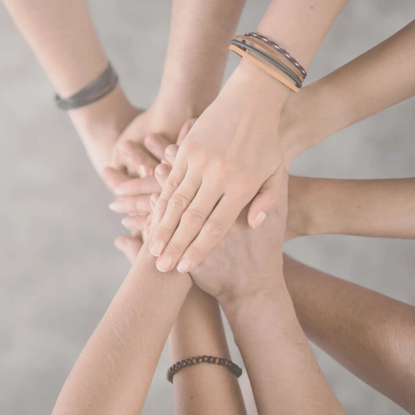 Heartfelt image showing volunteers with their hands together planning for charity awareness fundraiser events for school PTO and nonprofit fundraising.