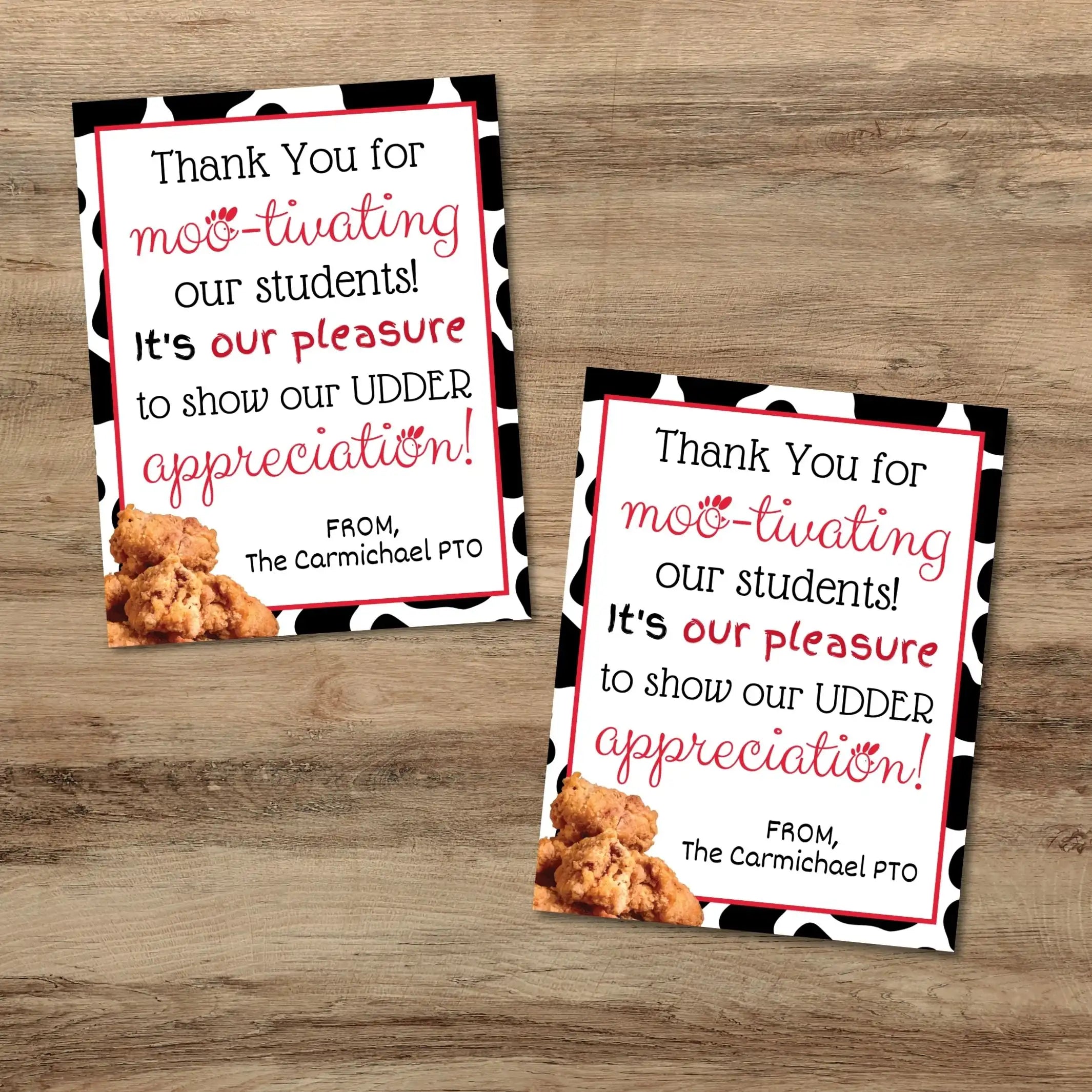 Two identical cards with text and a cow figure on a wooden surface with chicken nuggets for teacher appreciation gifts.