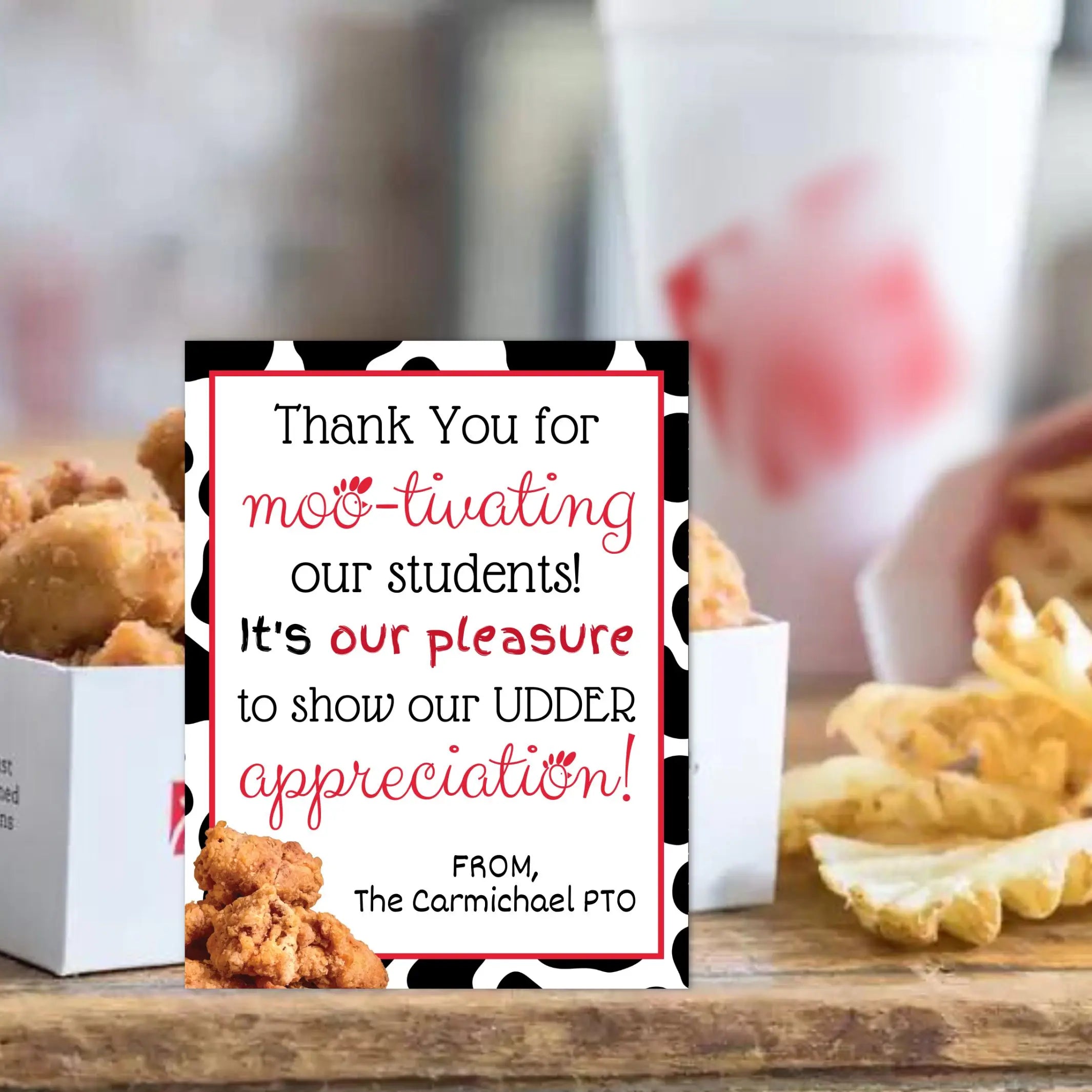 Card with humorous message about appreciation for teachers, placed on a table with chicken nuggets and waffle fries.