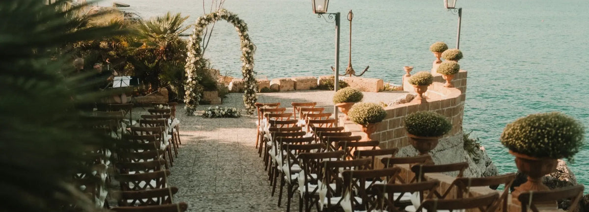 destination wedding castello di solanto sicily italy ceremony with white rose floral arch