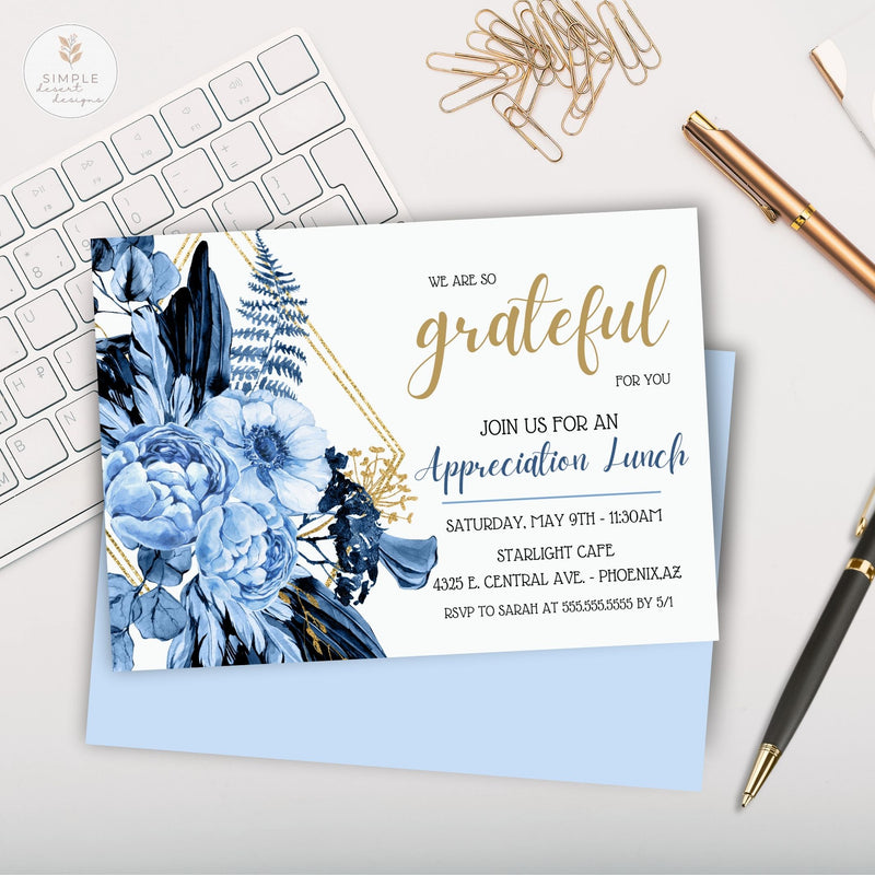 elegant blue and gold floral appreciation lunch invitation on white desk surface with keyboard, paper clips, pens and notebook by simple desert designs