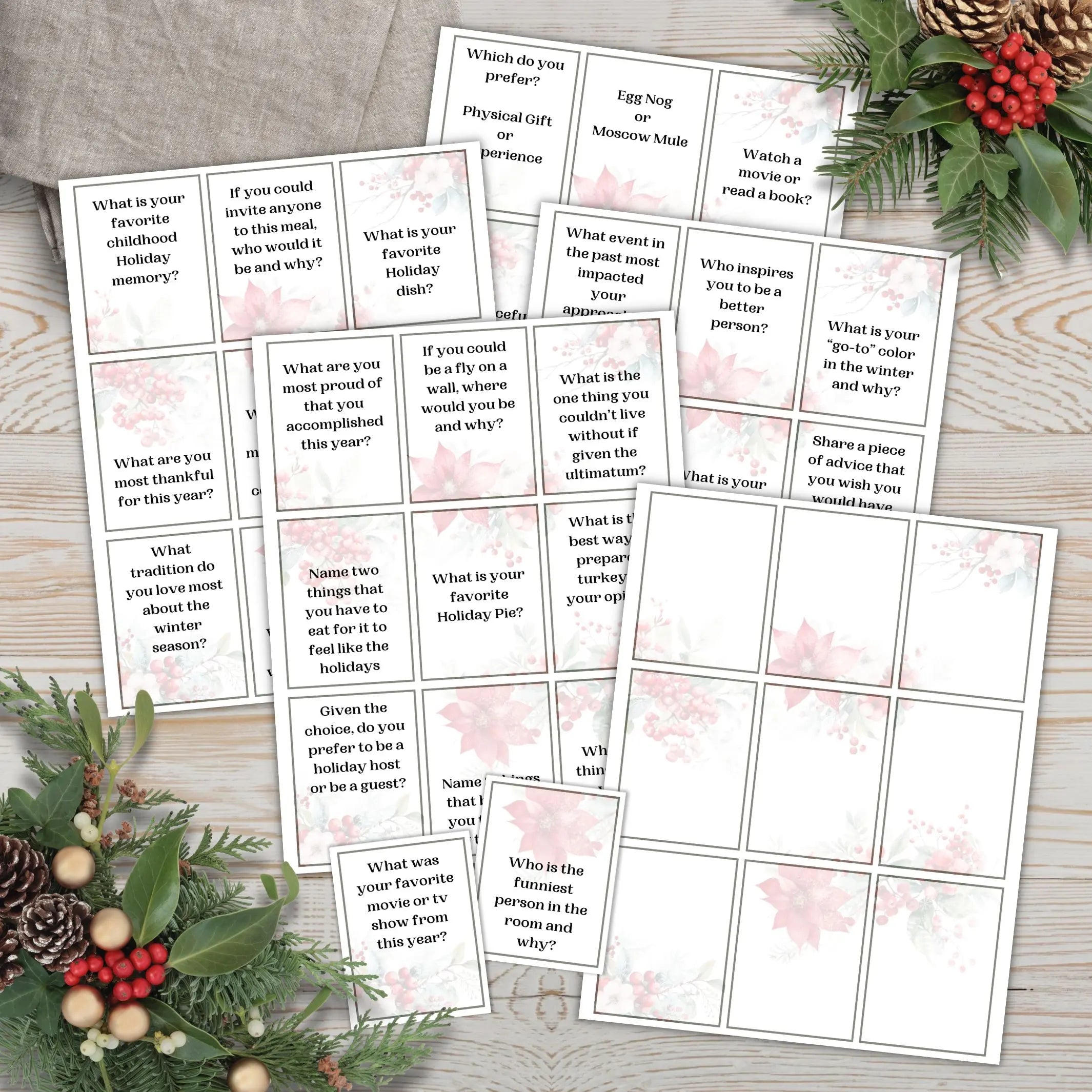 Image of 4 full printed pages of holiday icebreaker cards with 2 cut out and one blank sheet for Christmas or Holiday party conversation starters on light wood surface with holiday florals.