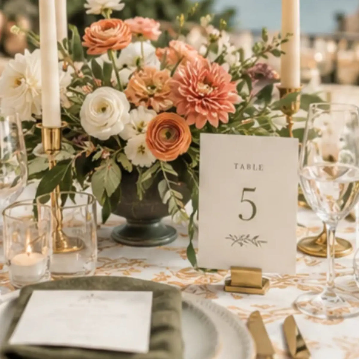 elegant wedding table setting with coral olive green plum accents table number card, menu for classic celebration