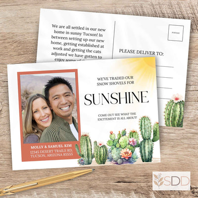 Elegant novelty botanical cactus we've moved new address card with a photo of a couple and cacti, on a wooden surface with a pen.