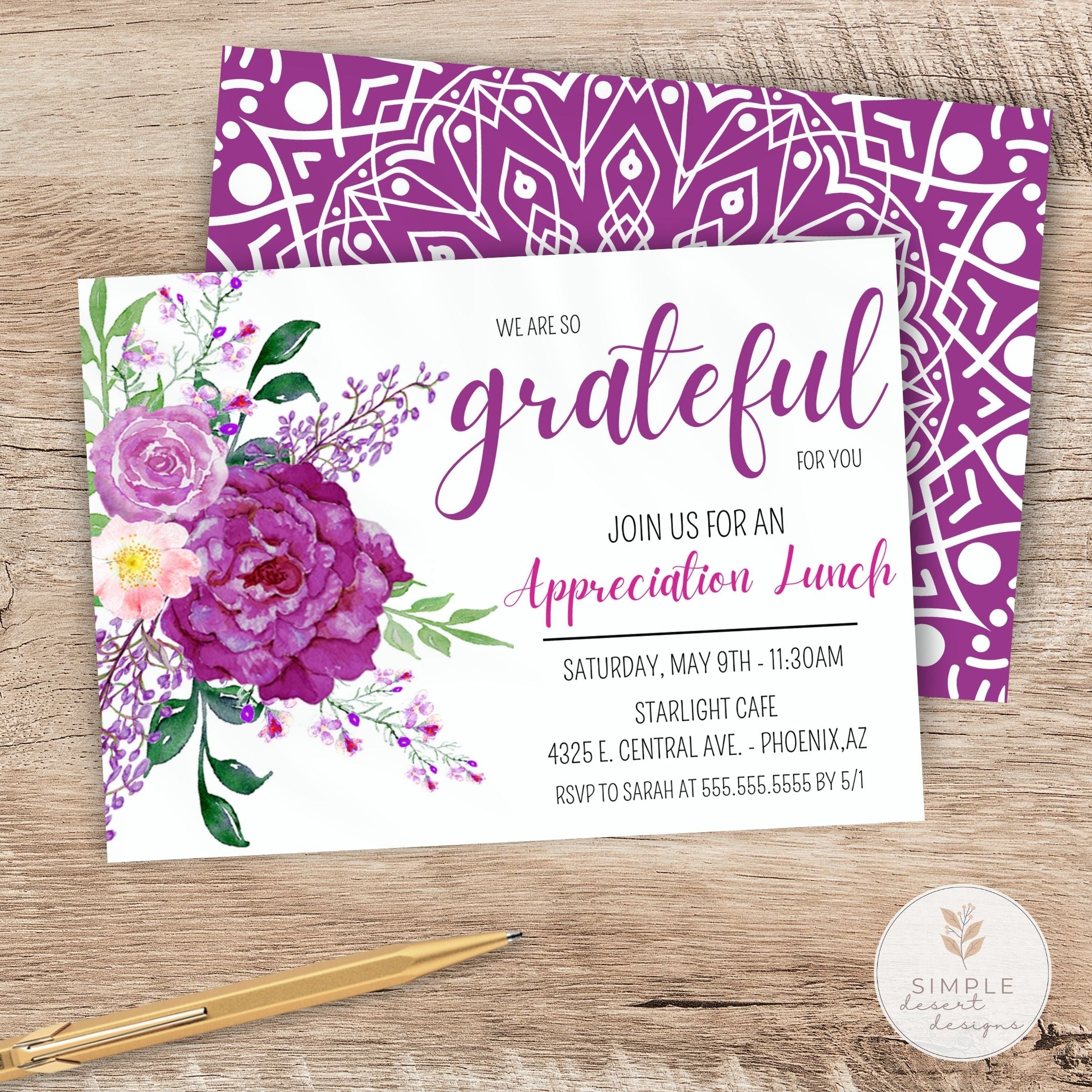 Invitation card with purple floral design and geometric pattern on a wooden surface.