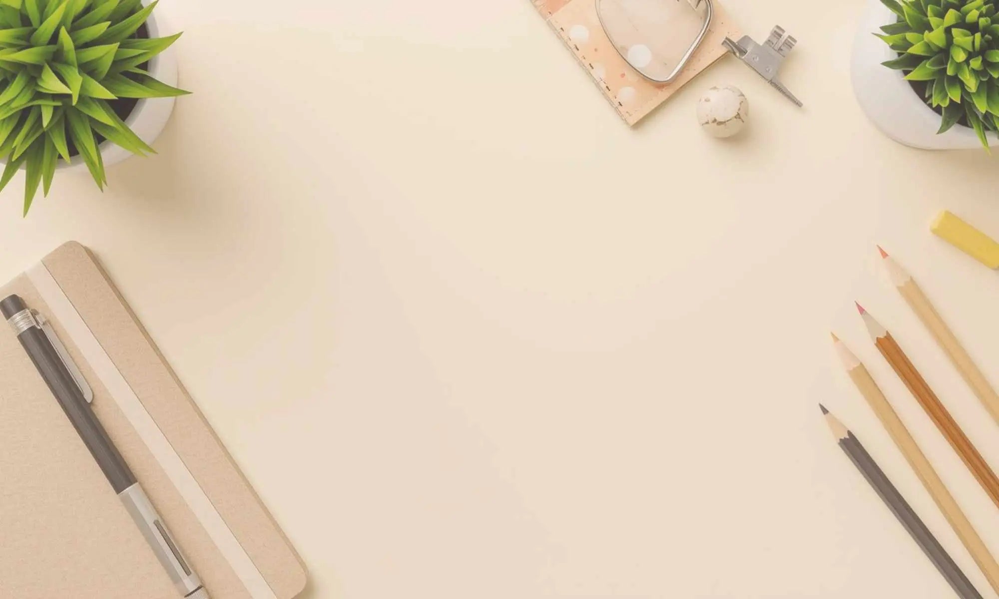 Desk with office supplies including pens, pencils, and a plant on a light background representing a page dedicated to teacher and classroom resources by Simple Desert Designs.