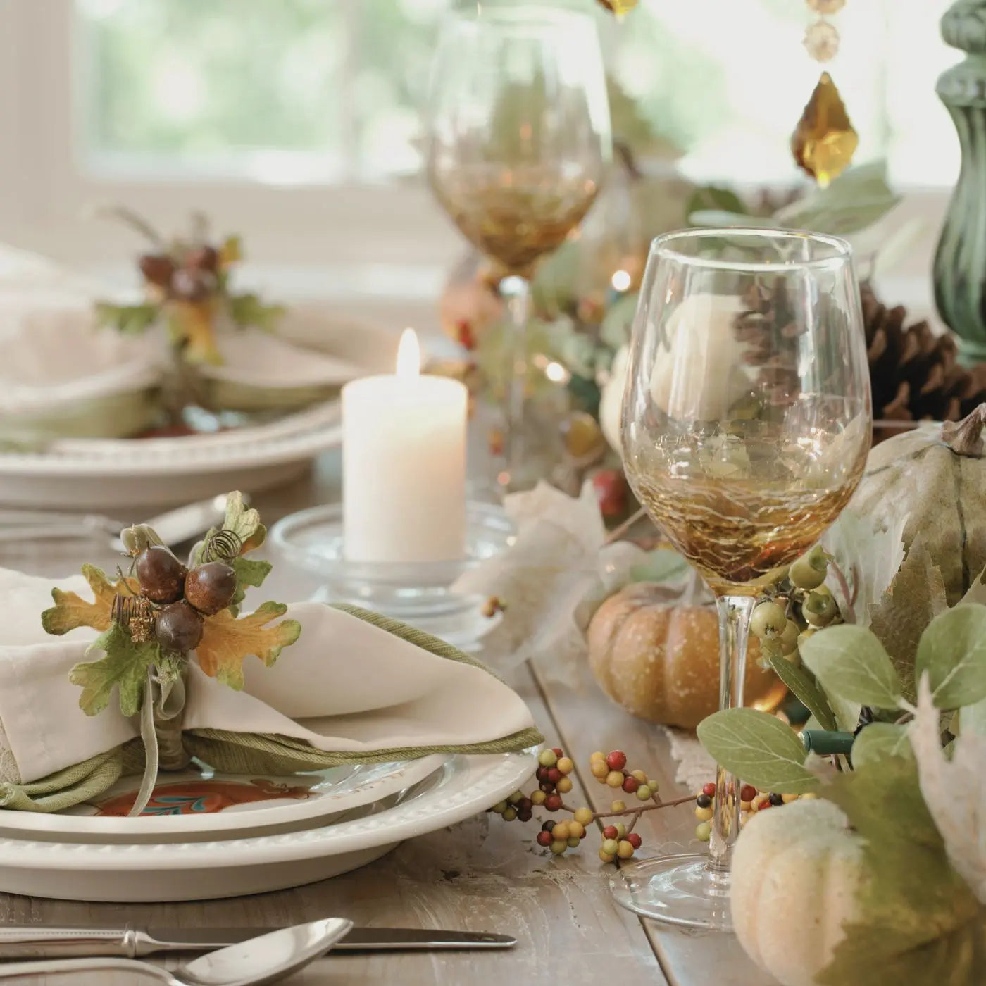 Thanksgiving table setting with pumpkins, candles, and decorative elements representing editable Thanksgiving invitations, flyers, tags, and event bundle templates.