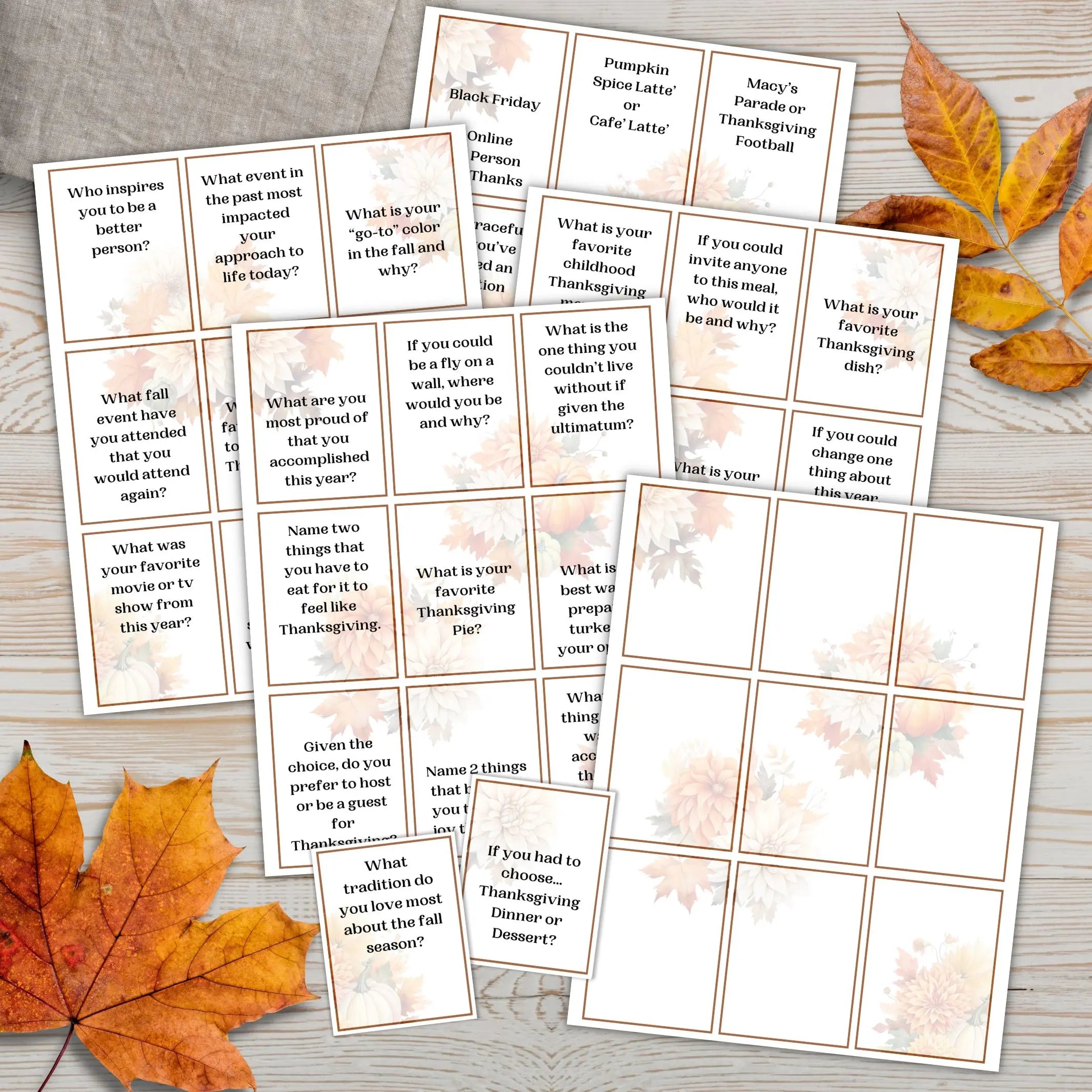 Set of Thanksgiving-themed ice breaker question cards on a wooden surface with autumn leaves.