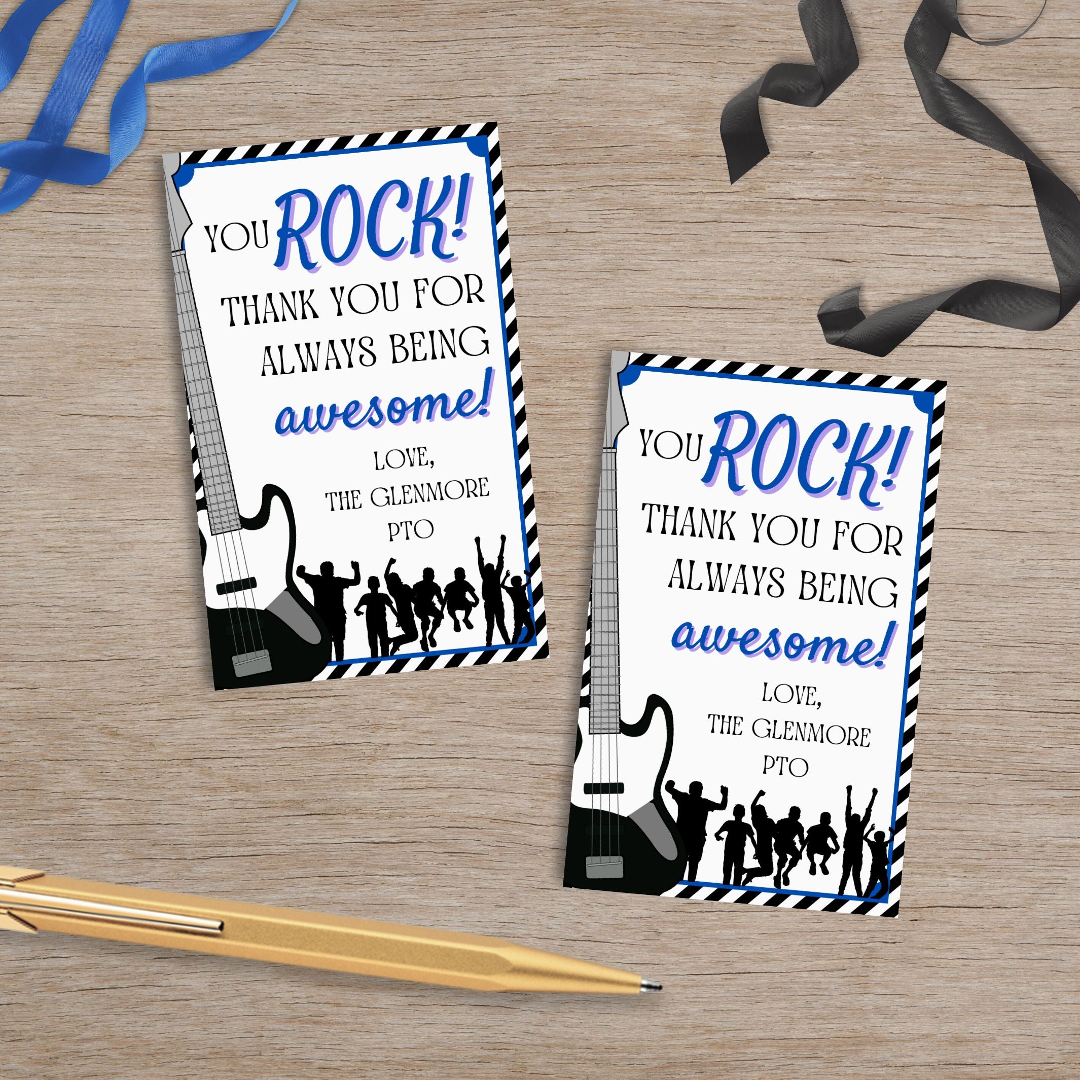 Two 'You Rock!' thank you gift tag cards on a wooden surface with ribbons and a pen.